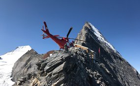 Symbolbild: Ein Rega-Helikopter auf dem Landplatz der Mittellegihütte