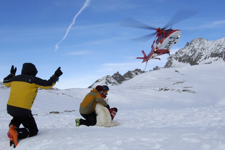 Ein Bergretter des Schweizer Alpen-Club SAC weist den Rega-Helikopter ein.